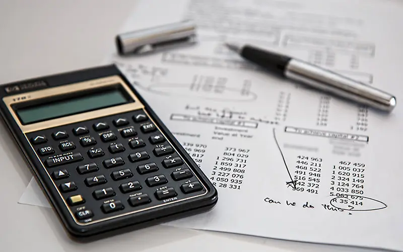 Calculator and numbers printed on paper