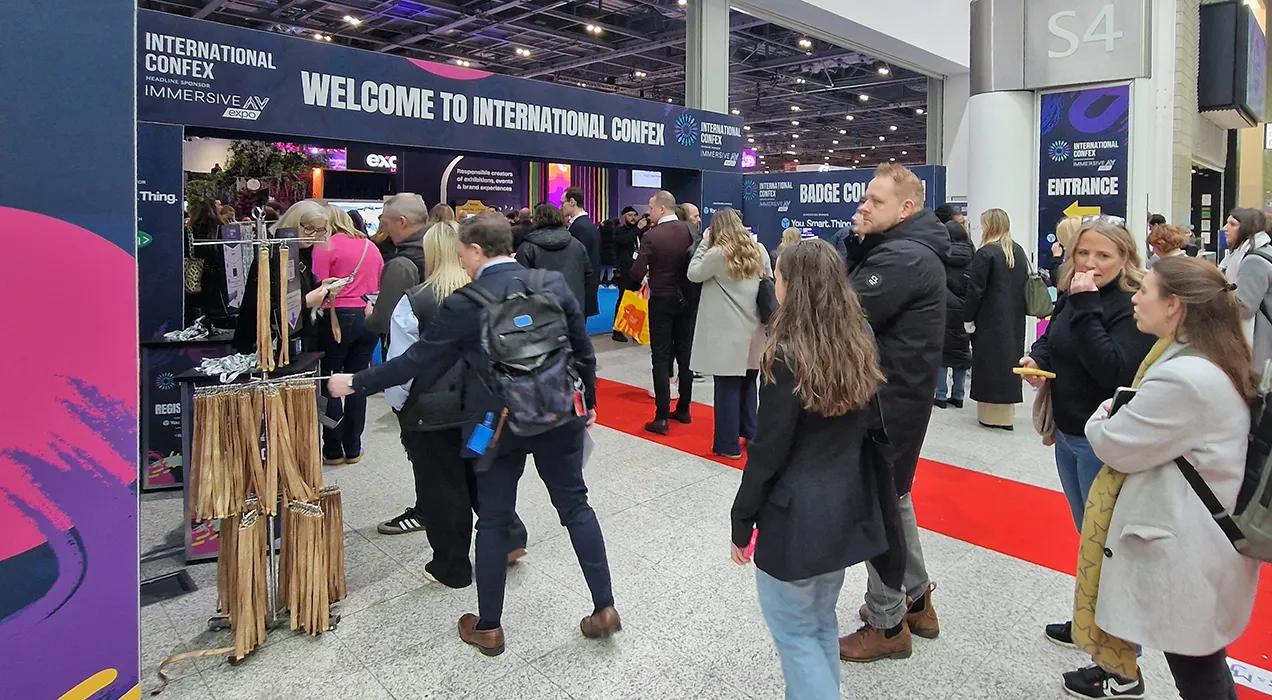 People entering an event, some are collecting their badge