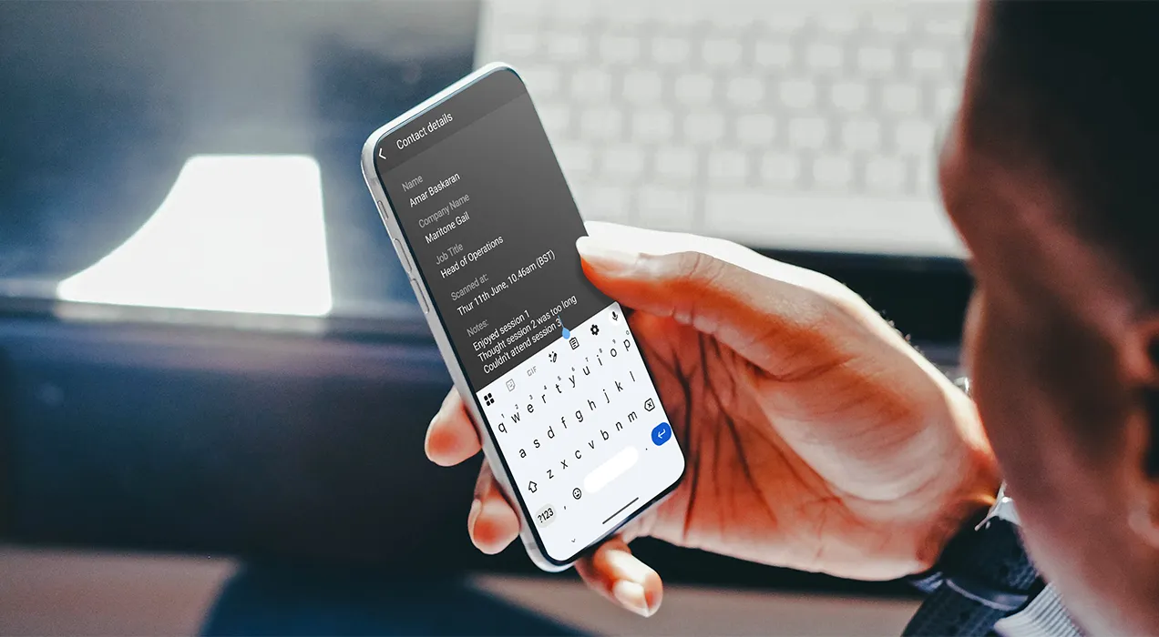 A man sitting at a desk adding notes in the ContactScanning app
