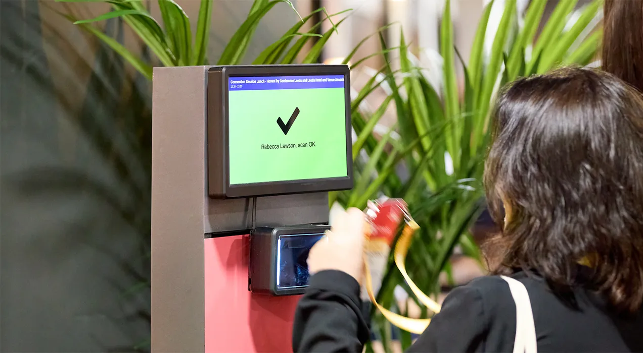Person scanning their badge at a ScanPod
